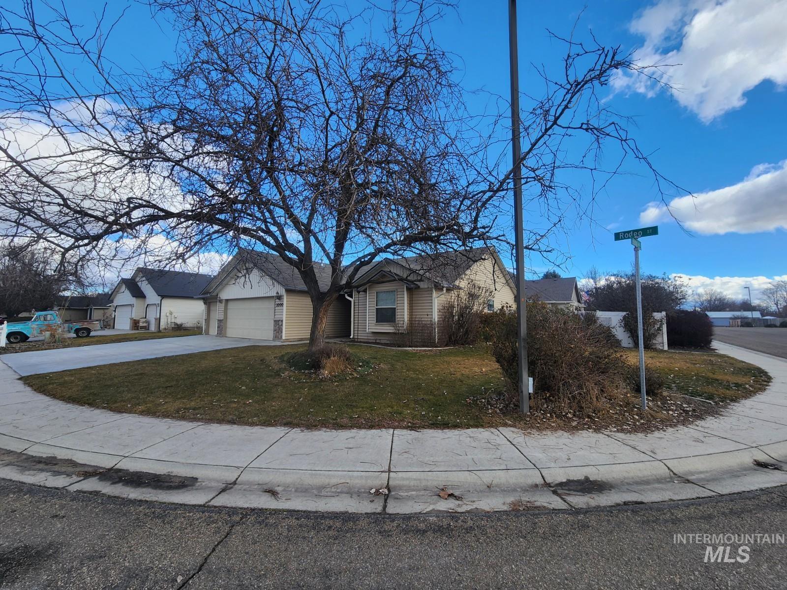 1000 North Rodeo Street Parma, ID 83660 - Photo 2 of 33 Single story home featuring driveway, a front lawn, a garage, and brick siding