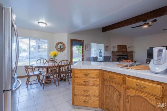 a kitchen with a dining table chairs and chandelier