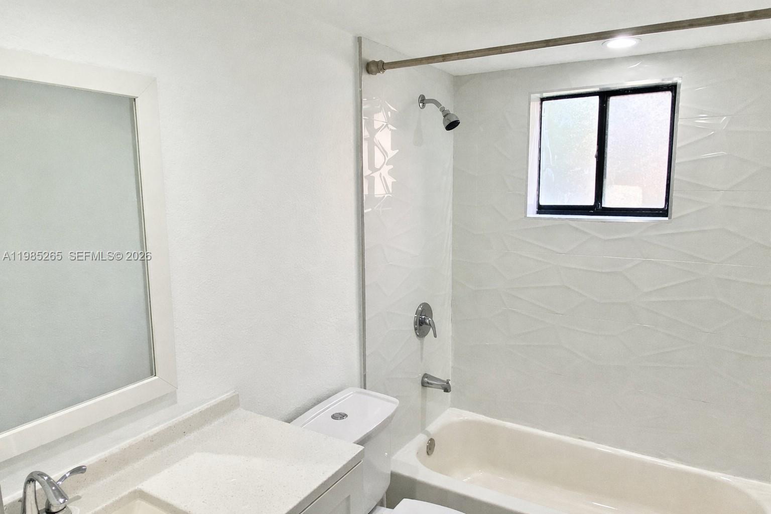 8520 Southwest 133rd Avenue Road, Unit 112 Miami, FL 33183 - Photo 2 of 11 a bathroom with a sink a toilet and shower