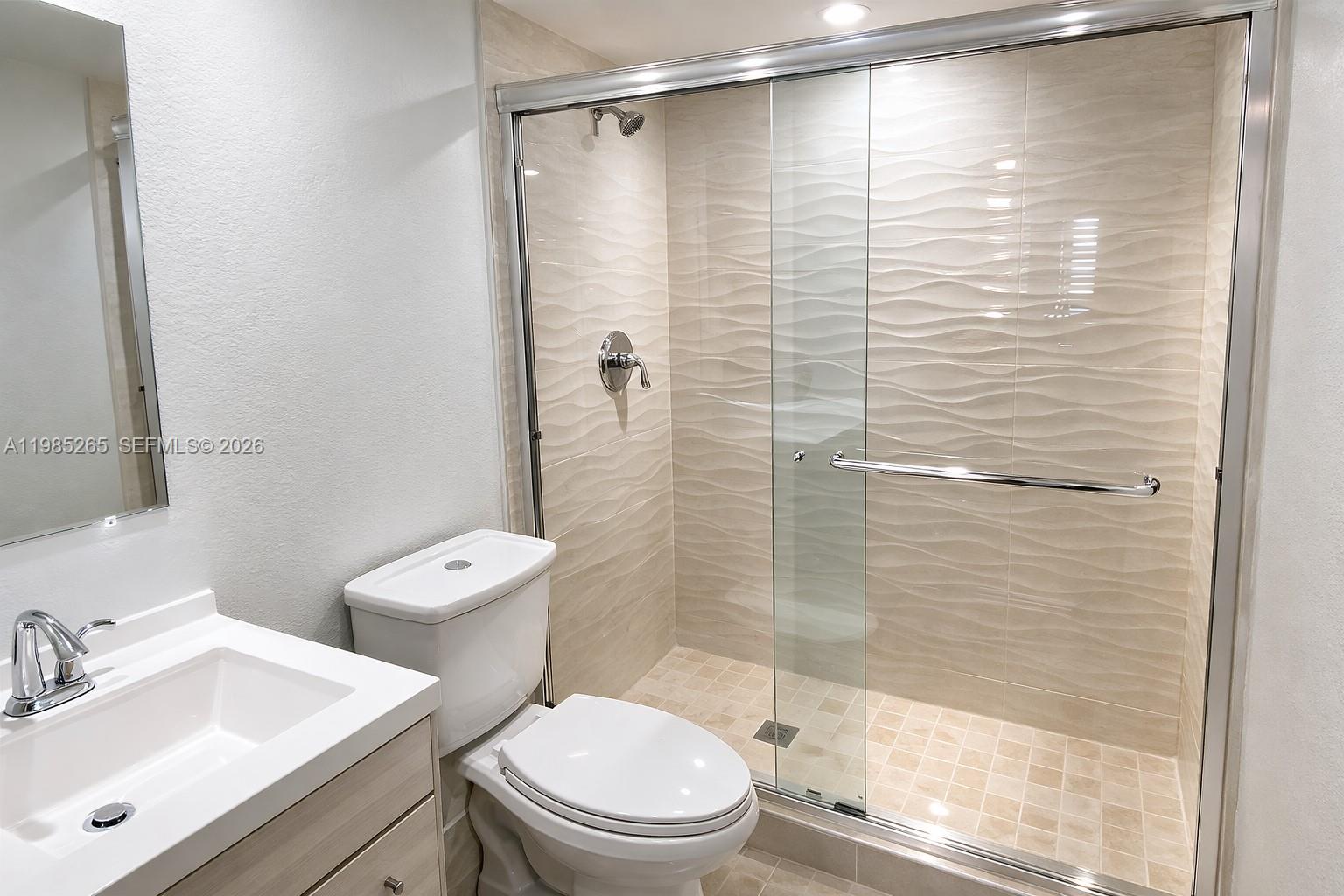 8520 Southwest 133rd Avenue Road, Unit 112 Miami, FL 33183 - Photo 3 of 11 a bathroom with a shower a toilet and sink