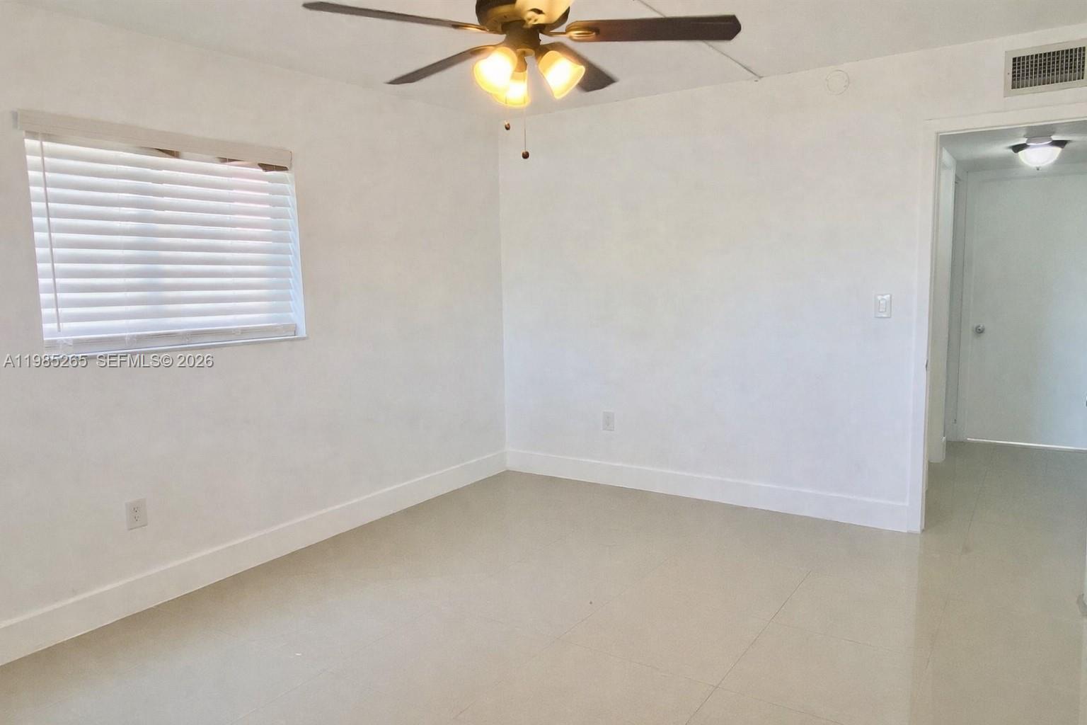 8520 Southwest 133rd Avenue Road, Unit 112 Miami, FL 33183 - Photo 8 of 11 an empty room with a window and a fan