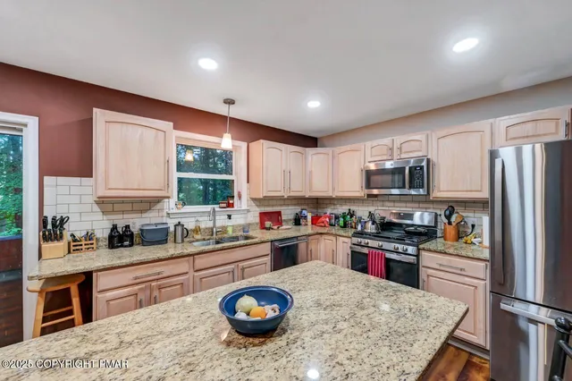 a view of empty room with wooden floor and windows