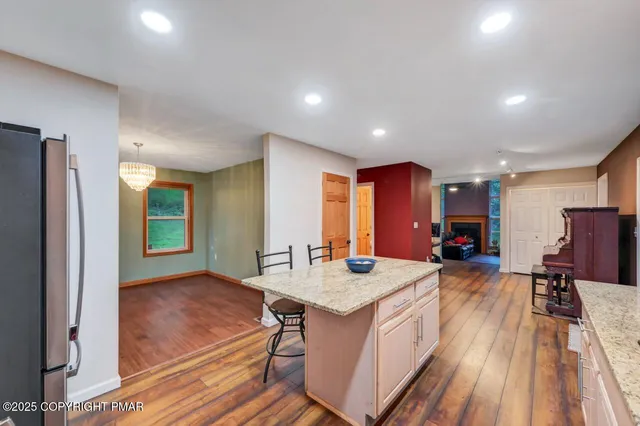 a view of staircase with wooden floor and white walls