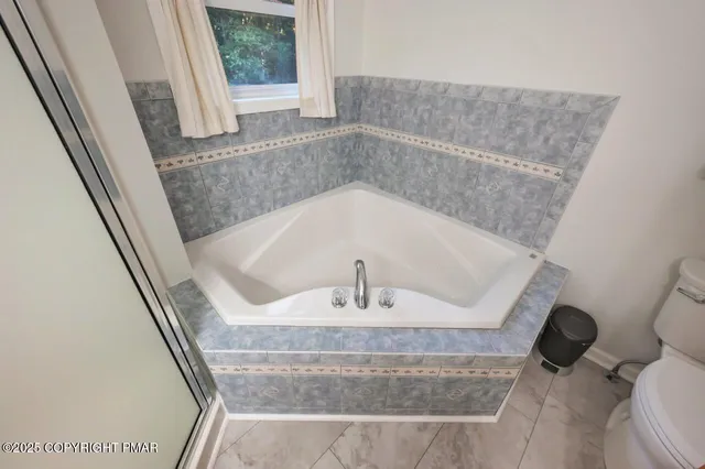 a view of a house with a yard patio and fire pit