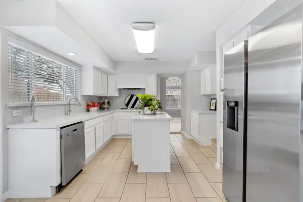 a kitchen with cabinets and window