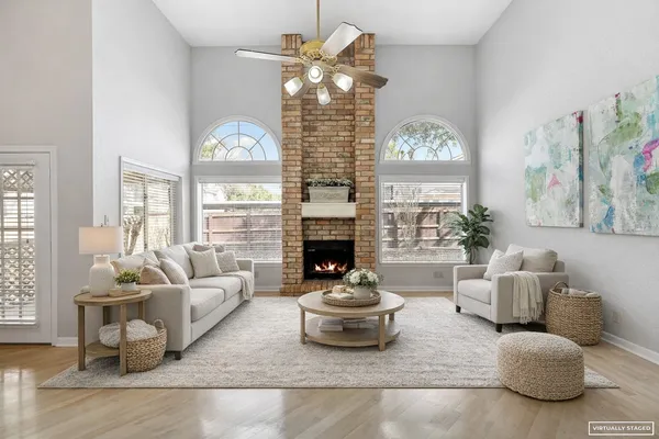 an empty room with windows and a fireplace