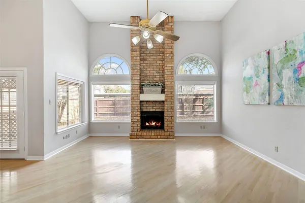 a living room with furniture a fireplace and a chandelier