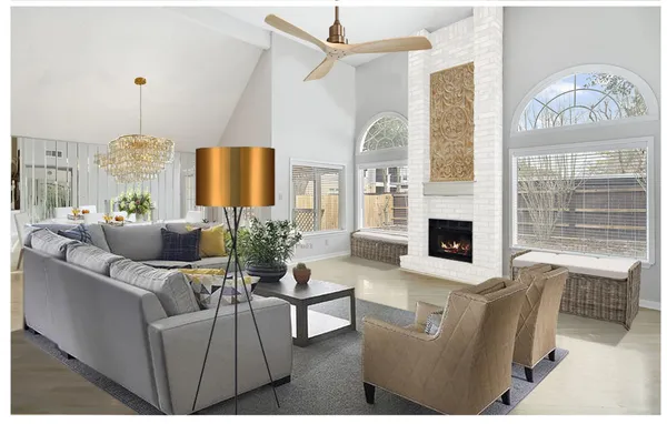 a view of an empty room with a fireplace and chandelier