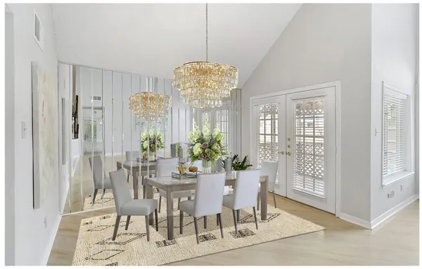 a view of an empty room with chandelier and window