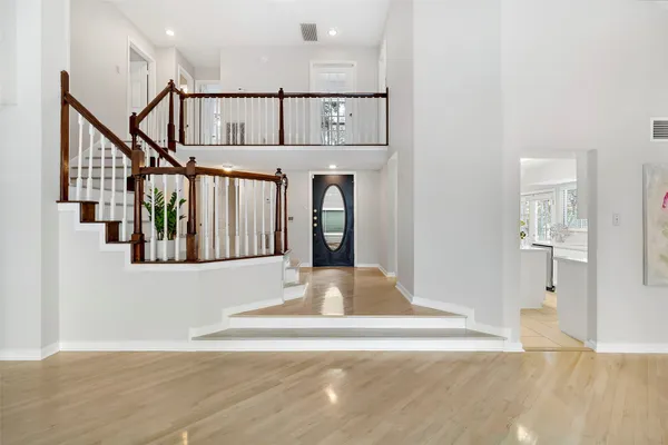 a view of a livingroom with wooden floor and a ceiling fan