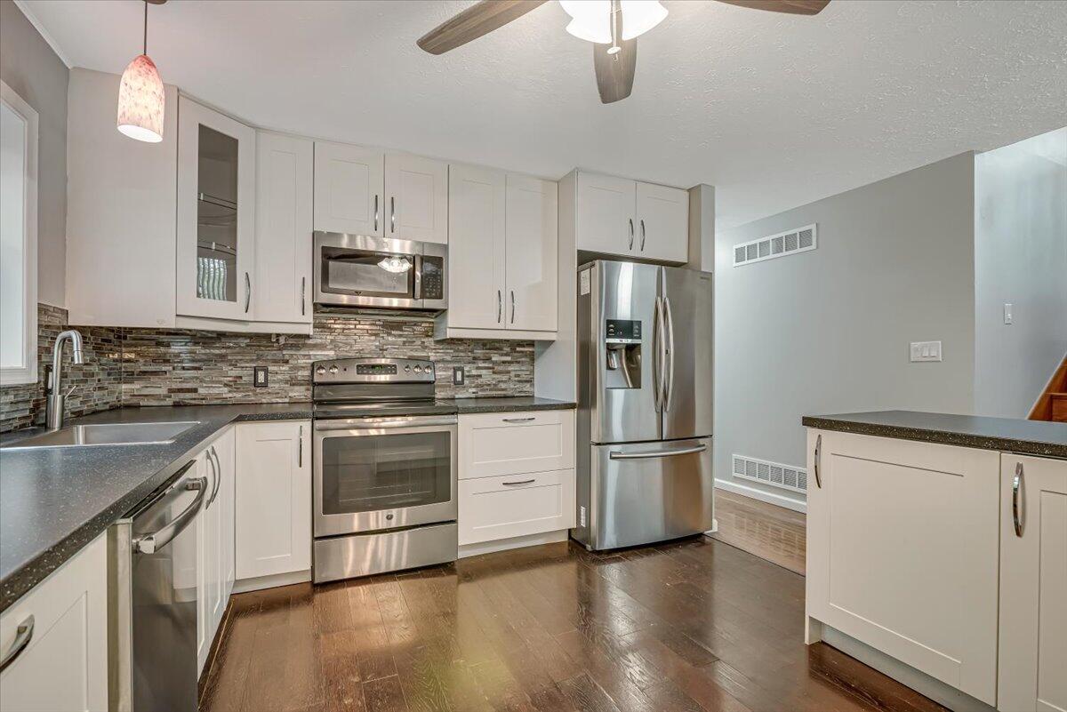 2330 Burntwood Drive East Stroudsburg, PA 18301 - Photo 11 of 44 a kitchen with stainless steel appliances a refrigerator a stove a sink and white cabinets