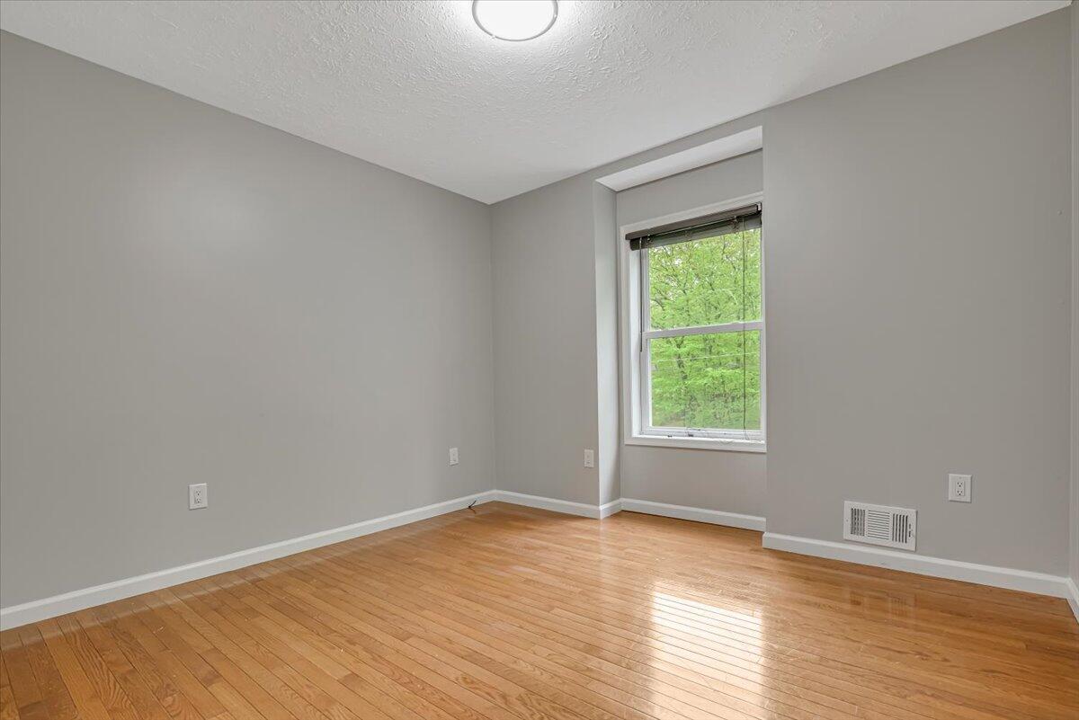 2330 Burntwood Drive East Stroudsburg, PA 18301 - Photo 16 of 44 a view of an empty room with wooden floor and a window