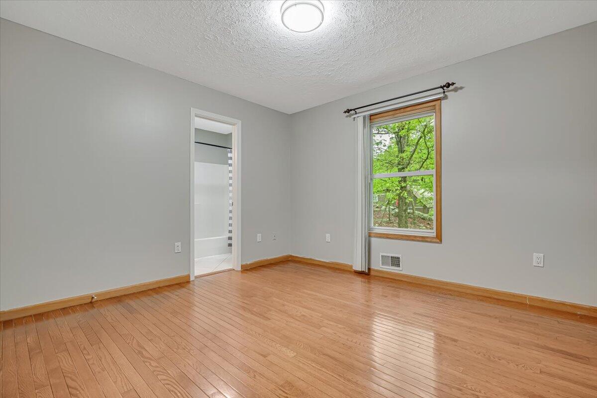 2330 Burntwood Drive East Stroudsburg, PA 18301 - Photo 19 of 44 an empty room with wooden floor and windows