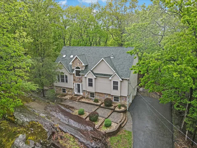 an aerial view of a house with yard and green space