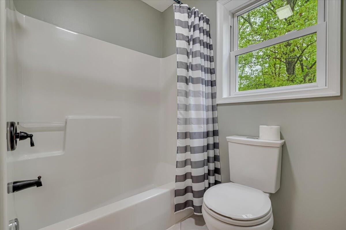 2330 Burntwood Drive East Stroudsburg, PA 18301 - Photo 21 of 44 a white toilet sitting next to a bath tub