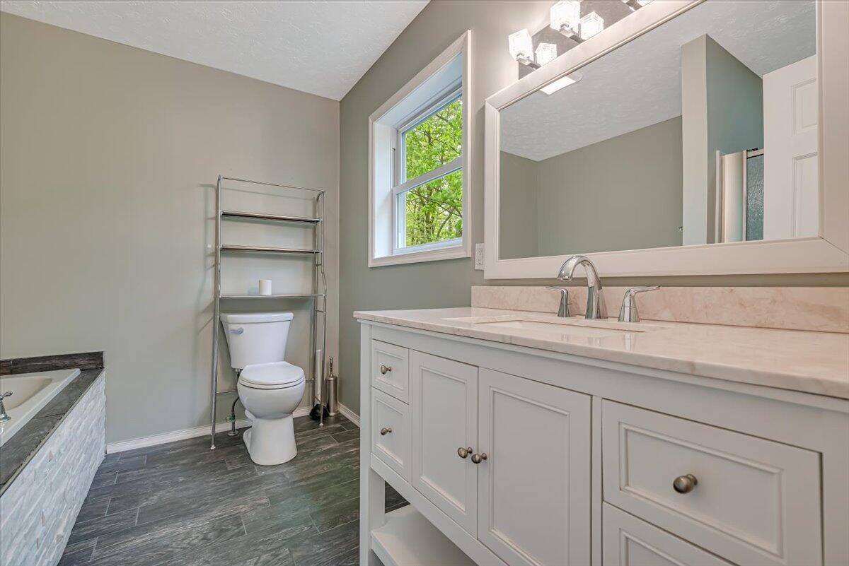 2330 Burntwood Drive East Stroudsburg, PA 18301 - Photo 29 of 44 a bathroom with a toilet sink and mirror