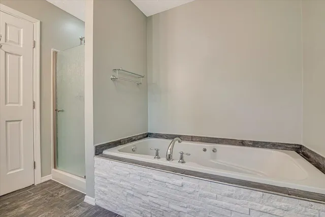a bathroom with a glass shower door and a glass door