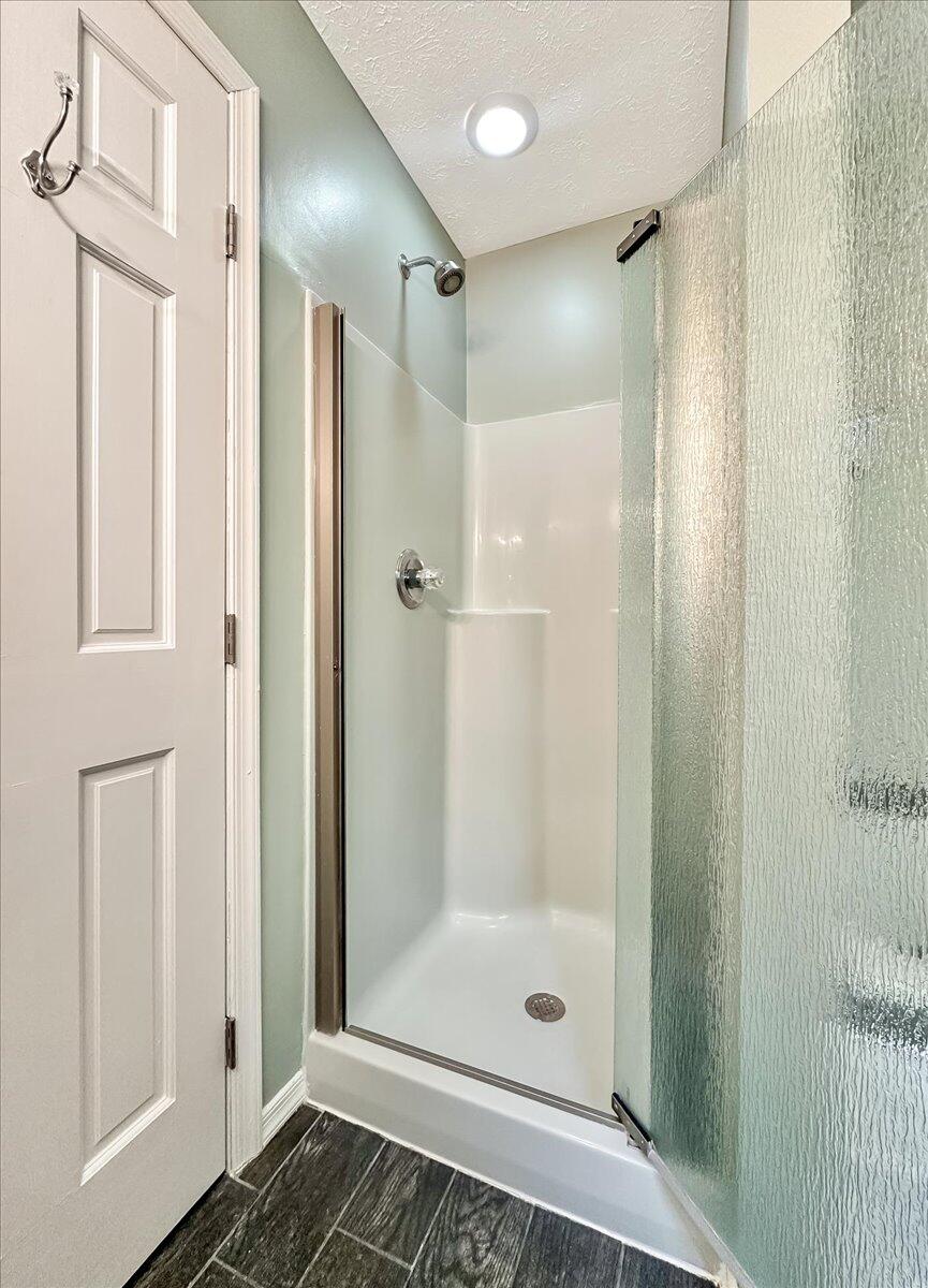 2330 Burntwood Drive East Stroudsburg, PA 18301 - Photo 32 of 44 a bathroom with a glass shower door and a glass door