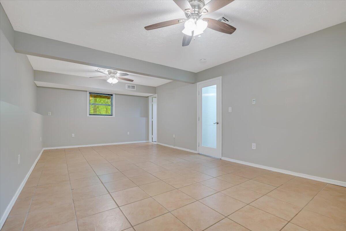 2330 Burntwood Drive East Stroudsburg, PA 18301 - Photo 34 of 44 an empty room with windows and chandelier fan