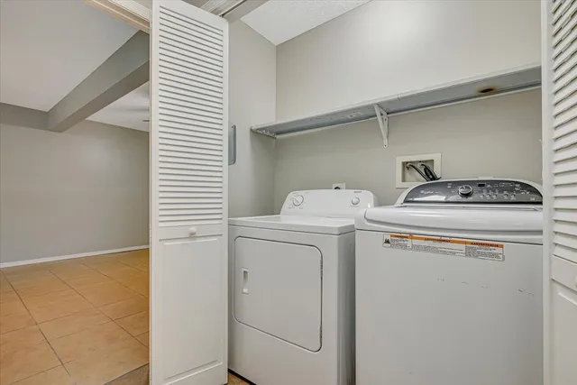 a large room with a large window and stainless steel appliances