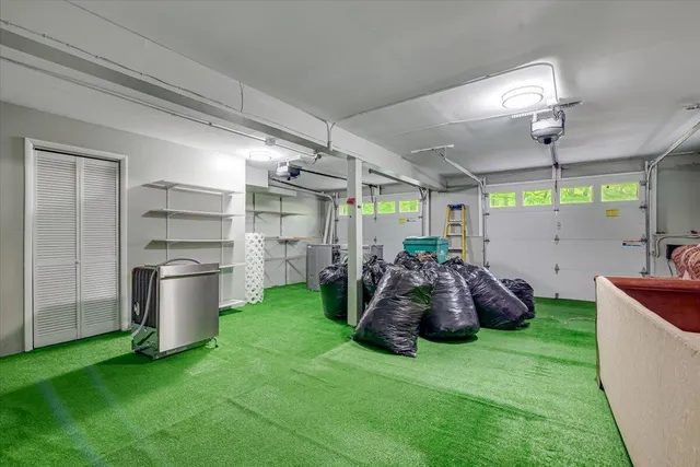 a view of a house with wooden deck and furniture