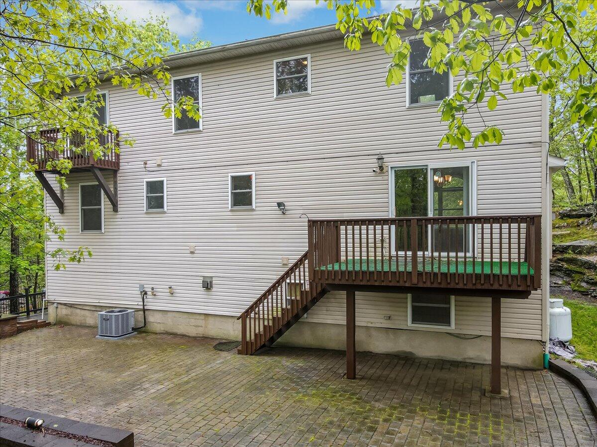 2330 Burntwood Drive East Stroudsburg, PA 18301 - Photo 39 of 44 a view of a house with a wooden deck and furniture