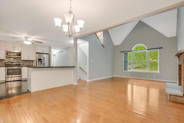 a view of a kitchen with wooden floor and a kitchen