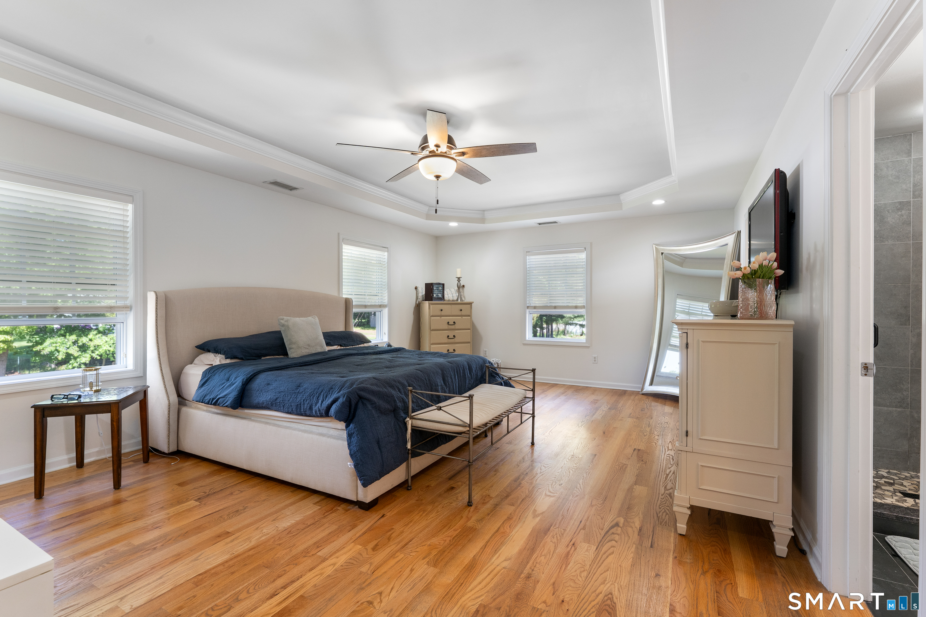 261 Spring Road North Haven, CT 06473 - Photo 23 of 39 a spacious bedroom with a bed and a chandelier