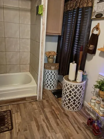 a bathroom with a bathtub and shower