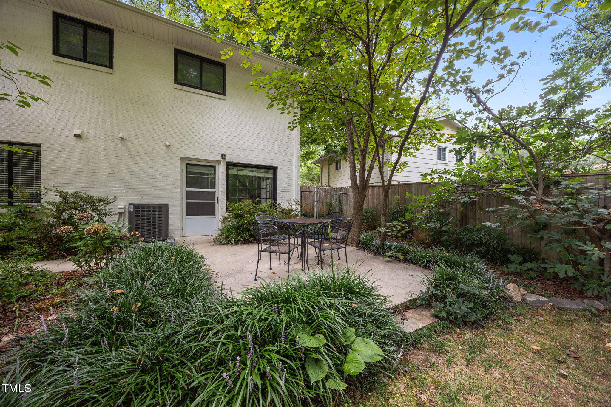 806 Beaver Dam Road Raleigh, NC 27607 - Photo 6 of 37 a view of a patio with table and chairs under an umbrella