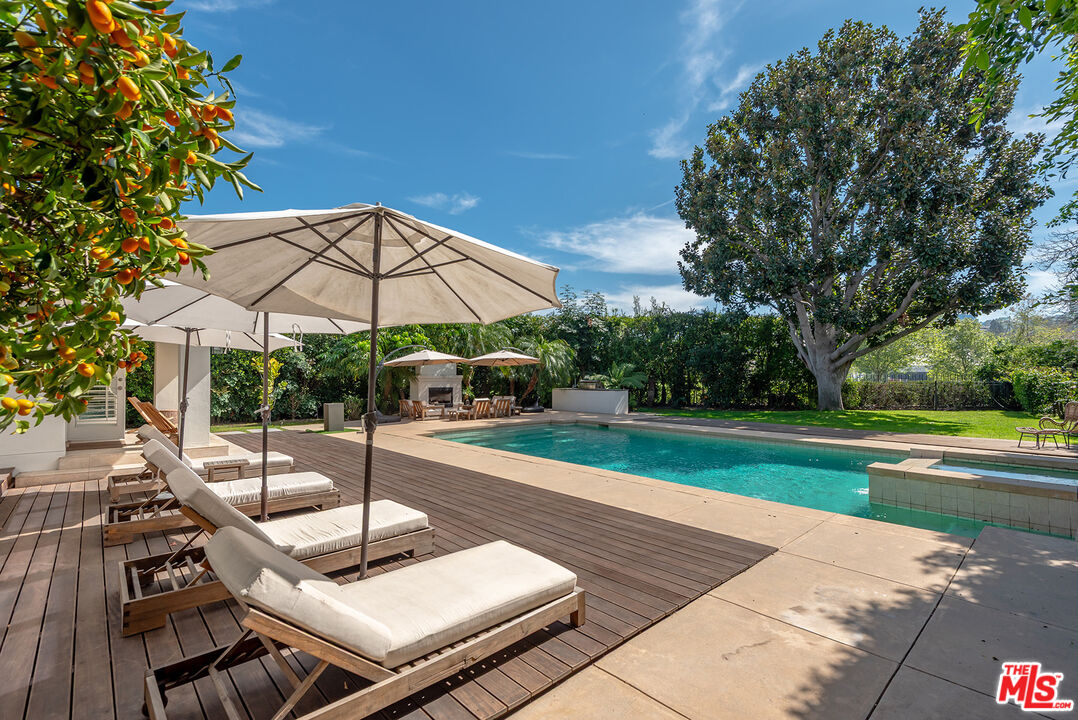 10424 Valley Spring Lane Toluca Lake, CA 91602 - Photo 26 of 44 a view of a patio with a table and chairs under an umbrella