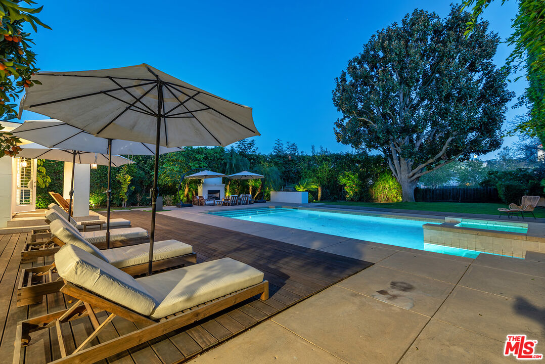 10424 Valley Spring Lane Toluca Lake, CA 91602 - Photo 33 of 44 a view of a backyard with swimming pool and sitting area