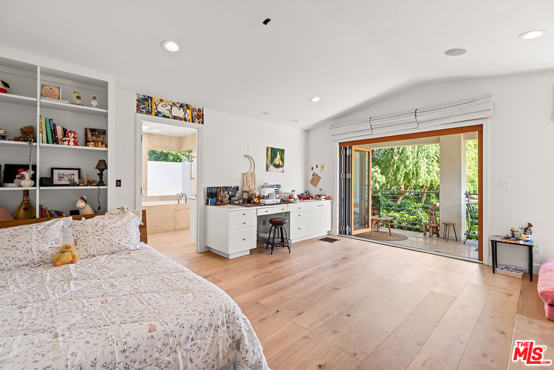 10424 Valley Spring Lane Toluca Lake, CA 91602 - Photo 37 of 44 a large bedroom with a large bed and a large window