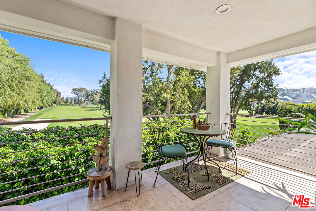 10424 Valley Spring Lane Toluca Lake, CA 91602 - Photo 39 of 44 a view of a chairs and table in patio with a yard