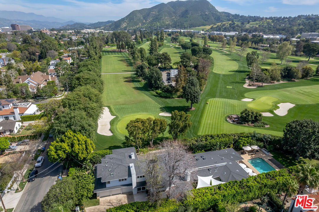 10424 Valley Spring Lane Toluca Lake, CA 91602 - Photo 41 of 44 an aerial view of green landscape with trees houses and mountain view