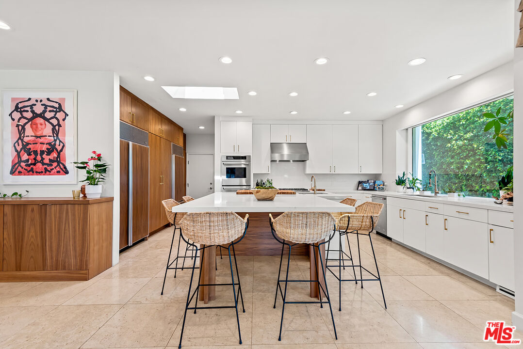 10424 Valley Spring Lane Toluca Lake, CA 91602 - Photo 10 of 44 a large kitchen with a table and chairs