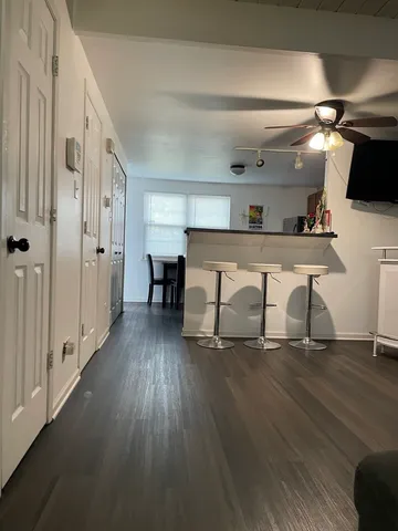 a view of a hallway with wooden floor and windows