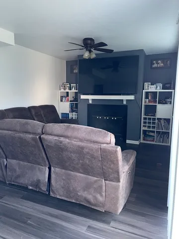 a living room with furniture and wooden floor