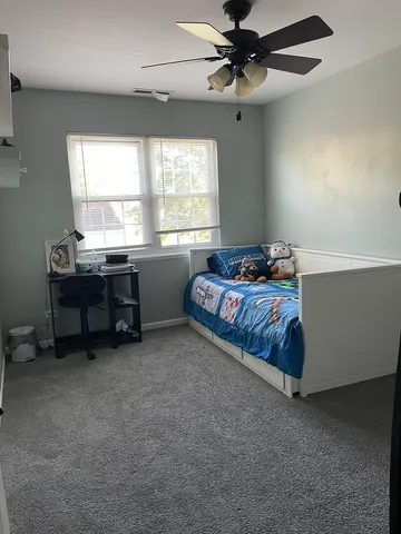 a bed room with a bed and a chandelier