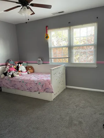 a bed room with a bed and a chandelier