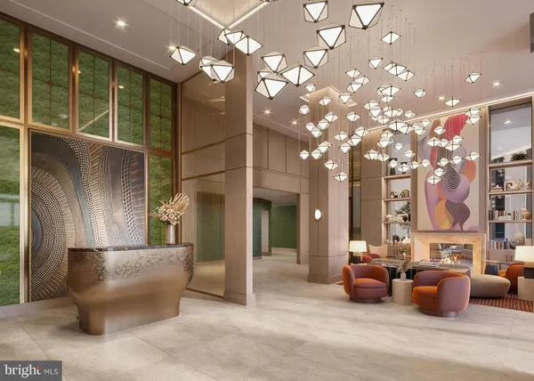 a lobby with furniture and chandelier