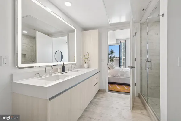 a bedroom with a bed and a flat tv screen on dresser