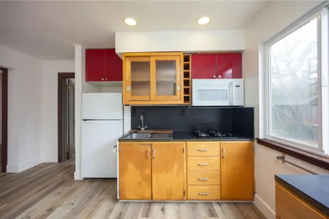 a kitchen with stainless steel appliances granite countertop a stove a refrigerator and a microwave