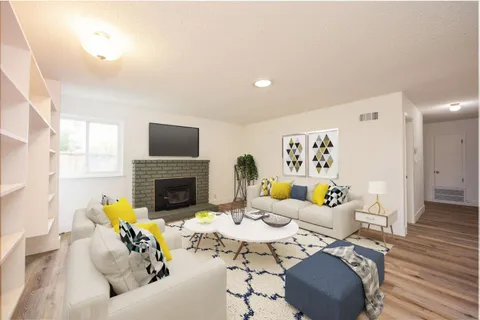 a living room with furniture a fireplace and a flat screen tv