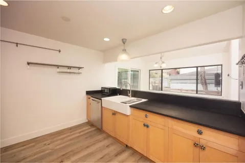 a kitchen with a stove a sink and a refrigerator