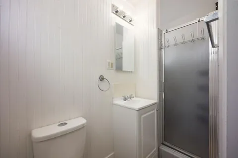 a bathroom with a shower a toilet and sink