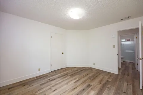 a view of room with wooden floor