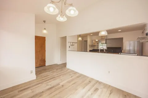a view of a kitchen with a sink and a refrigerator