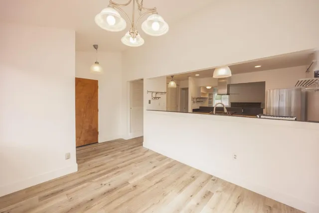 a view of a kitchen with a sink and a refrigerator