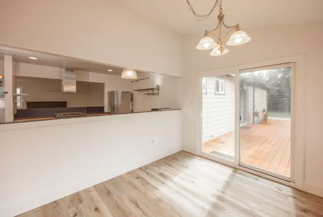 a view of a kitchen with a sink and refrigerator